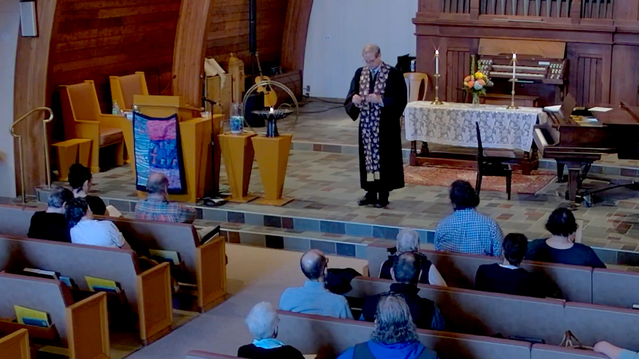 Image from video. Rev. F. Vernon Wright V stands in front of the congregation.